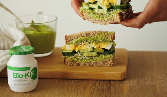 Hummus with fresh herbs sandwich with a bottle of Bio-K+
